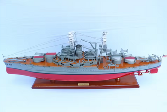 Model of a USS Arizona naval ship on a light blue background